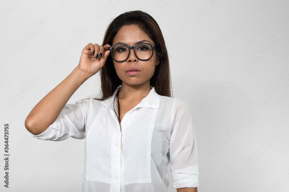 Portrait of Asian woman with eyeglasses looking at camera Portrait of Asian woman with eyeglasses looking at camera