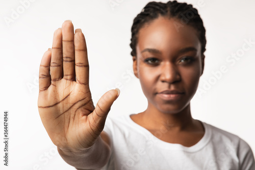 African American Girl Gesturing Stop Posing Over White Studio Background photo