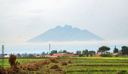 MUSANZE, RWANDA -  Mt Sabinyo volcano seen from the city of Musanze (former Ruhengeri) surrounded by morning mist. It stands at the border with DRC in Volcanoes National Park photo