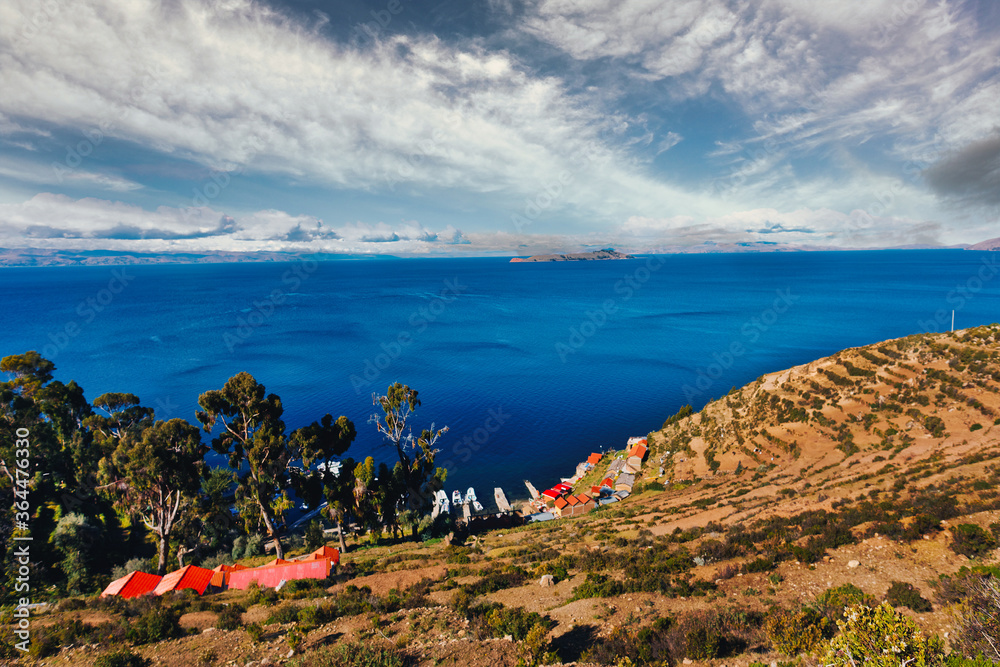 View of the Titicaca Lake on the border of Peru and Bolivia. By volume of water, it is the largest lake in South America.It is often called the highest navigable lake in the world.