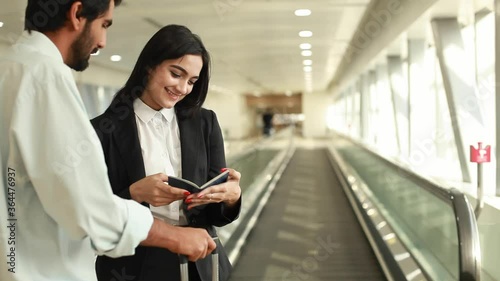 Beautiful Indian visa officer checking passport of a Pakistani man and smiling