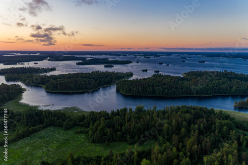Sunrise over the islands of the water world in Karelia. Aerial view. © alexkazachok