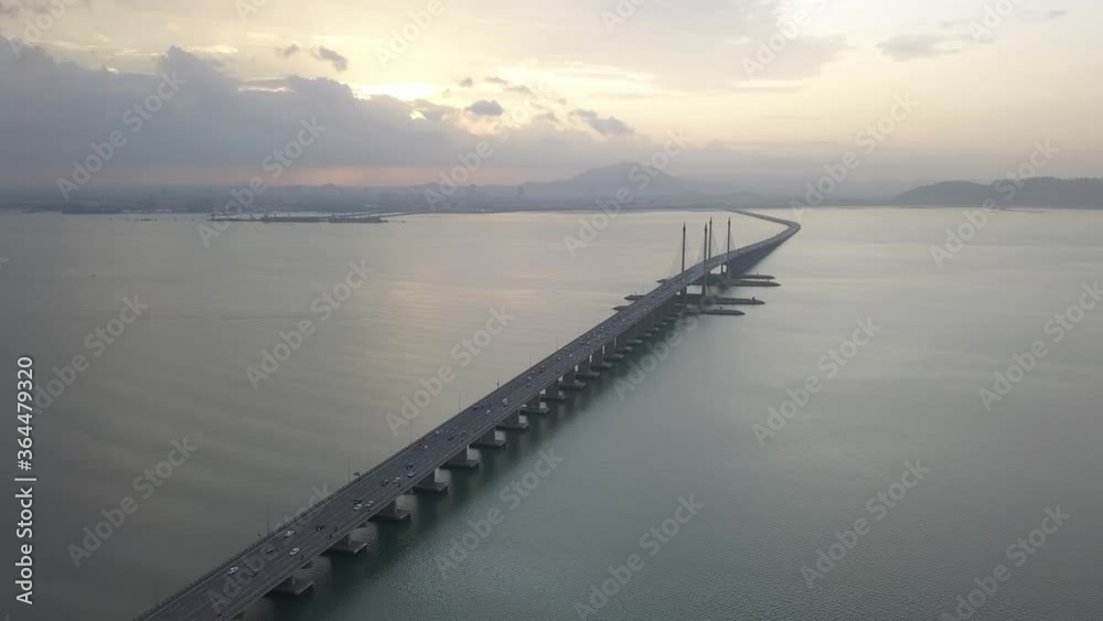 Aerial view morning sunrise at Penang Bridge. Car traffic move to work between island and mainland. Aerial view morning sunrise at Penang Bridge. Car traffic move to work between island and mainland.