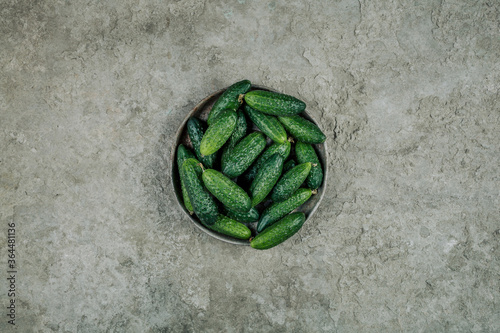 Still life with fresh cucumbers on a concrete background. The view from the top. Art.