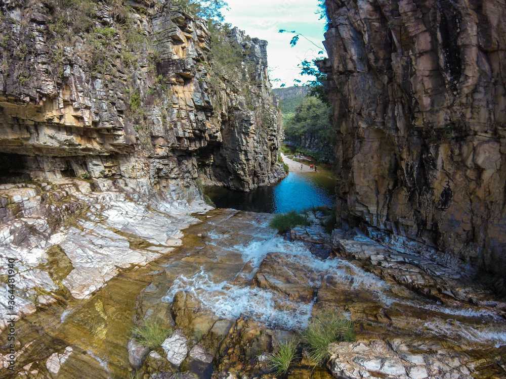 Large canyon with a small river running across the rocks at Serra da Canastra region in Brazil. Large canyon with a small river running across the rocks at Serra da Canastra region in Brazil.