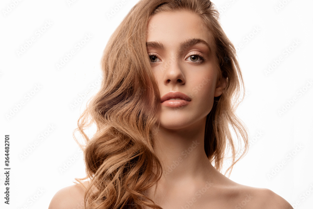 Young woman with perfect skin. Studio portrait on white background. Natural nude makeup. Girl with beautiful hair. Young woman with perfect skin. Studio portrait on white background. Natural nude makeup. Girl with beautiful hair.