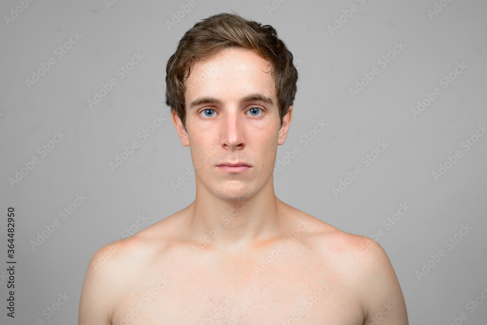 Face of young handsome man looking at camera shirtless Face of young handsome man looking at camera shirtless