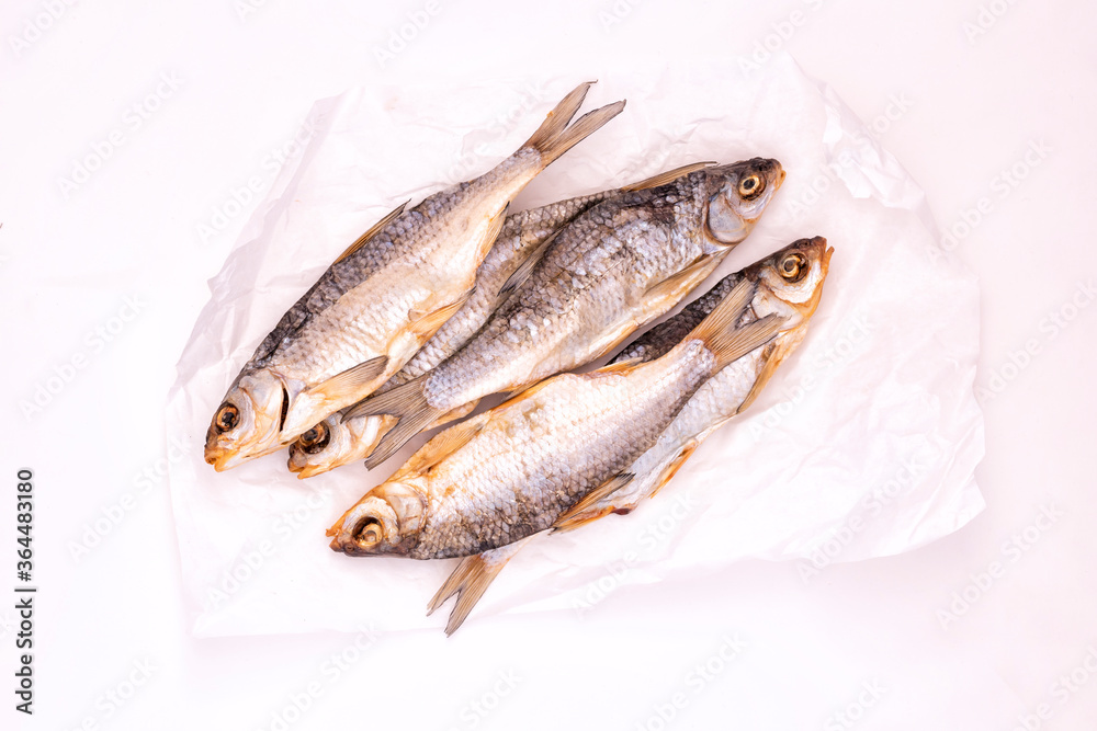 Few dried fishes on the crumpled white paper
Few dried fishes on the crumpled white paper