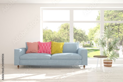 White stylish minimalist room with sofa and smmer landscape in window. Scandinavian interior design. 3D illustration © AntonSh