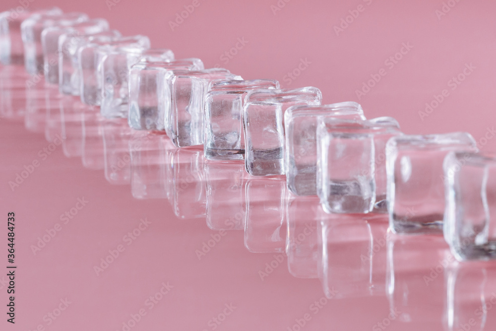 Ice cubes on a pink background. Art photo. Minimalism. Ice cubes on a pink background. Art photo. Minimalism.