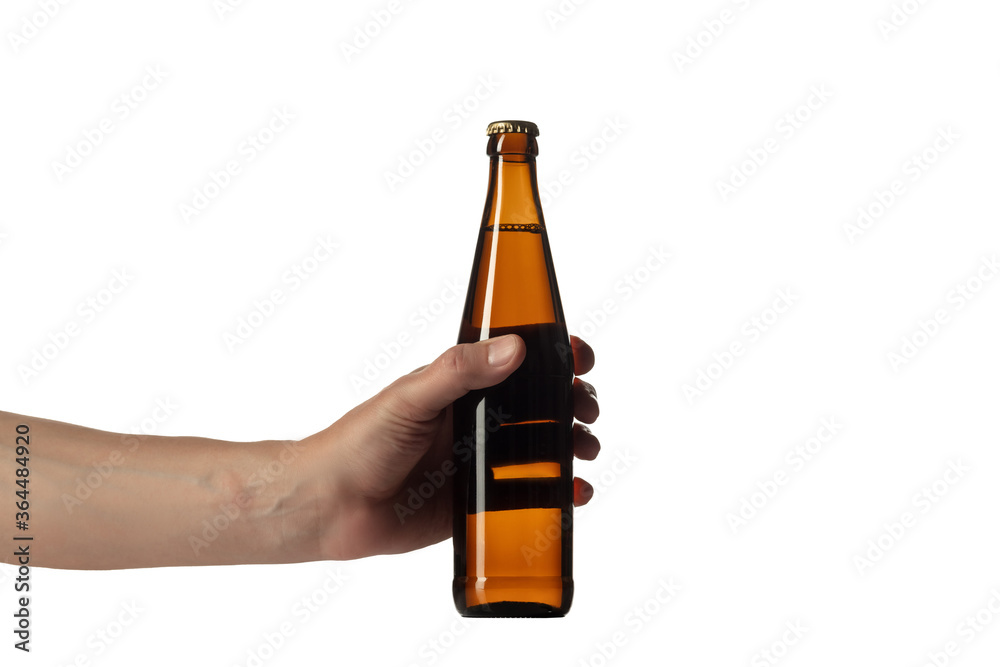 Empty golden colored beer bottle in male hand isolated on white studio background. Concept of beer, beverage, entertainment and alcohol. Copyspace for your bar, restaurant, brewery or shop advertising Empty golden colored beer bottle in male hand isolated on white studio background. Concept of beer, beverage, entertainment and alcohol. Copyspace for your bar, restaurant, brewery or shop advertising