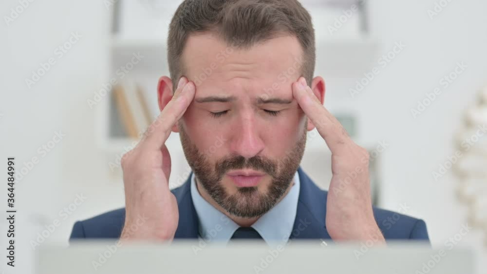 Working Businessman with Laptop having Headache Working Businessman with Laptop having Headache