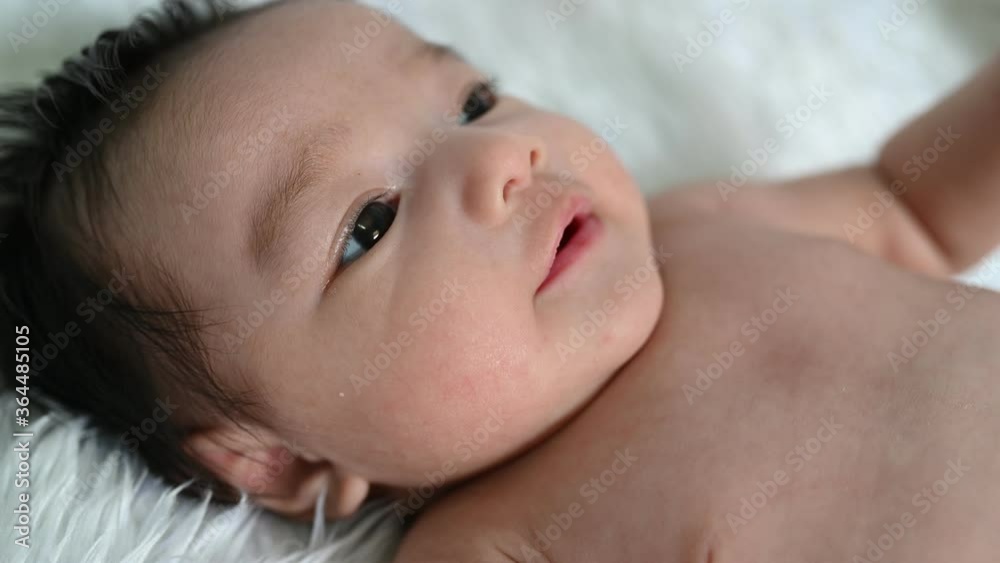 Closeup asian baby lying on the bed,Cute thailand little girl Closeup asian baby lying on the bed,Cute thailand little girl
