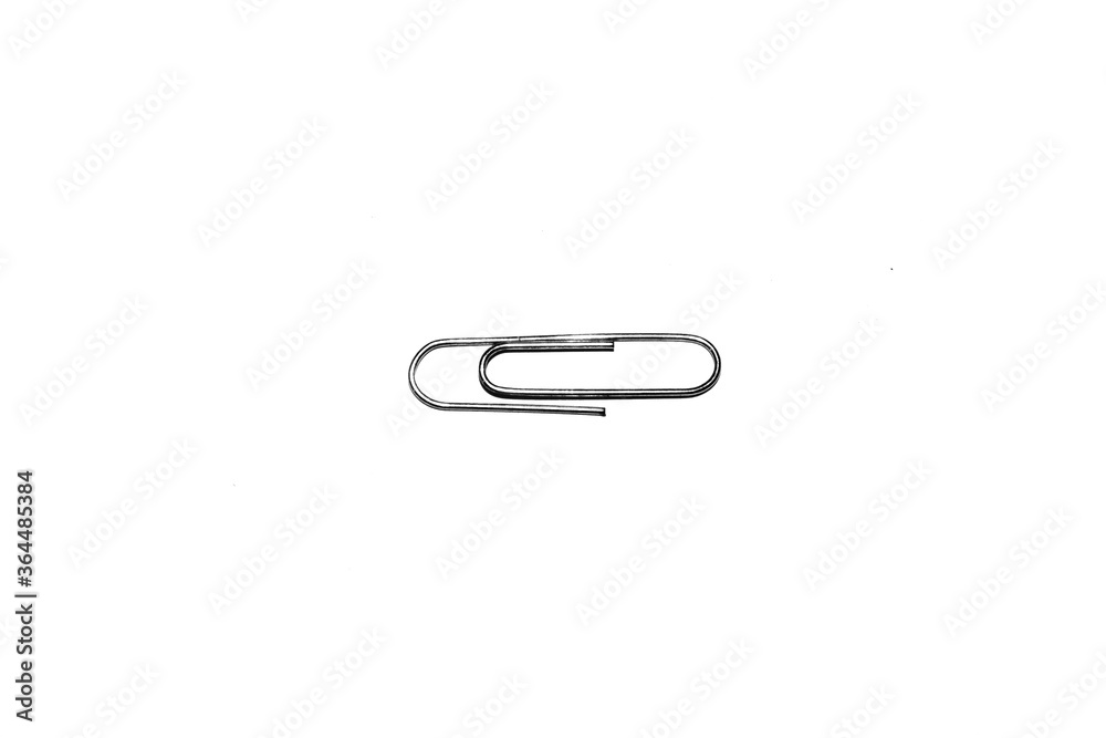 Single silver paper clip isolated on white studio background. Paper clip background / texture
Single silver paper clip isolated on white studio background. Paper clip background / texture