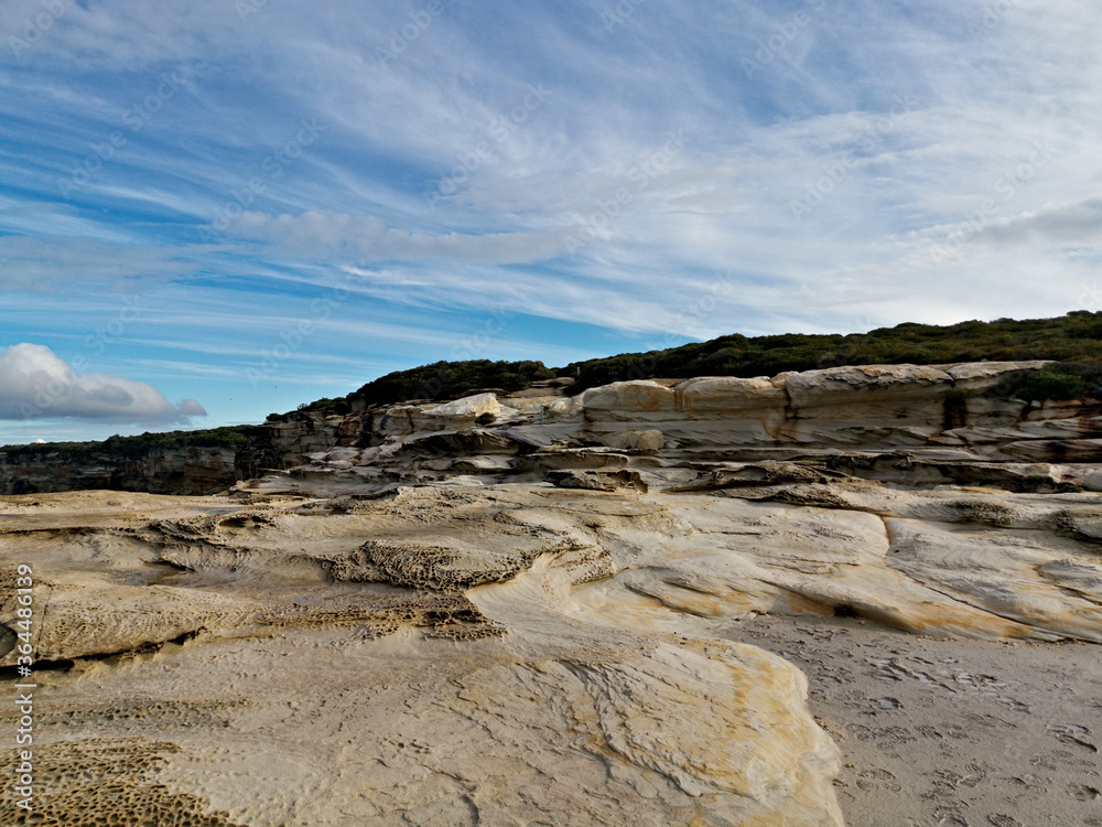 Beautiful coastal trail with colorful rock formations near Wattamolla Beach, Royal National Park, New South Wales, Australia
