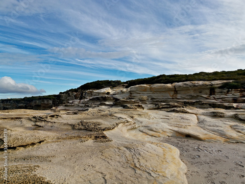 Beautiful coastal trail with colorful rock formations near Wattamolla Beach, Royal National Park, New South Wales, Australia 