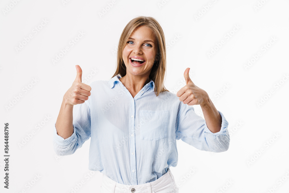 Image of happy blonde woman showing thumb up and smiling at camera Image of happy blonde woman showing thumb up and smiling at camera