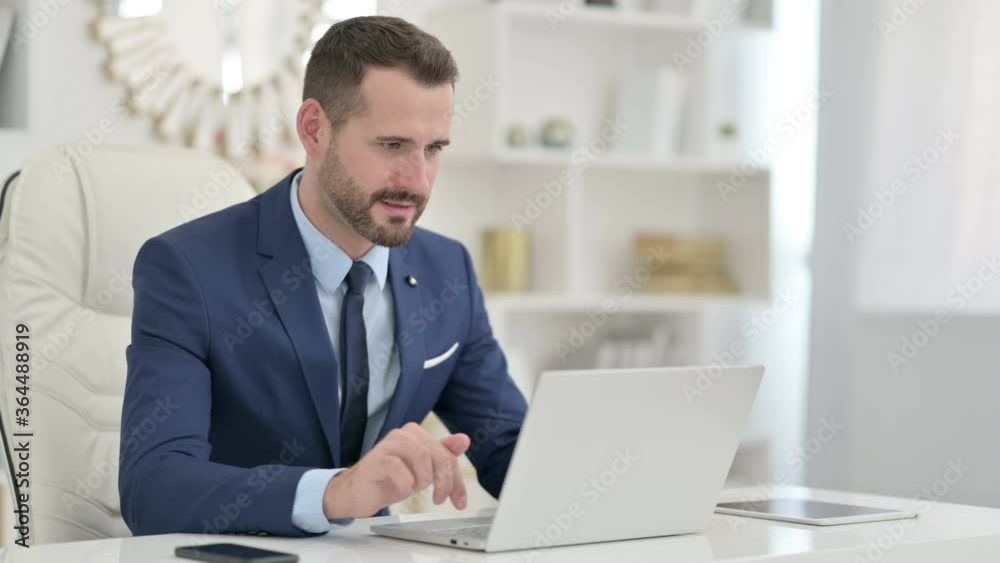 Businessman Celebrating Success on Laptop in Office Businessman Celebrating Success on Laptop in Office