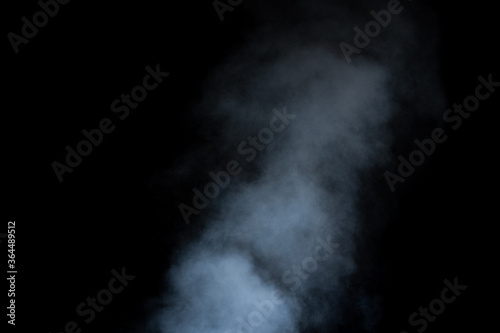 Close-up curls of steam or smoke with drops of moisture isolated on black background, low key, copy space