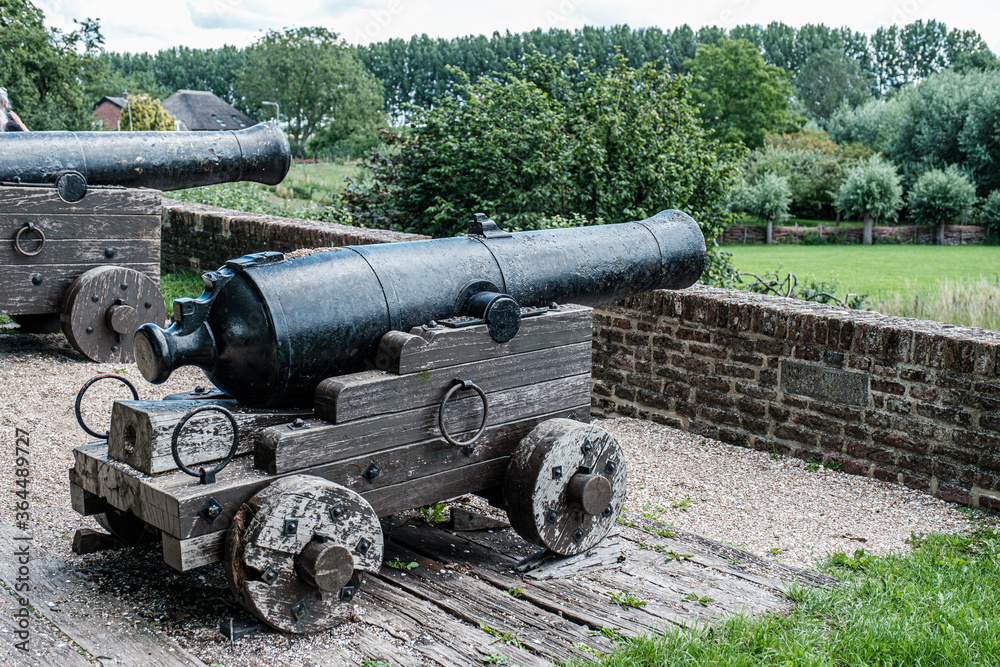 Cannon near city wall in old fortified town Buren, The Netherlands in summer. Cannon near city wall in old fortified town Buren, The Netherlands in summer.