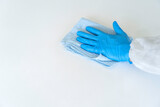Closeup hand with glove in virus protective suite wiping and cleaning covid19 infected area, Virus disinfection concept