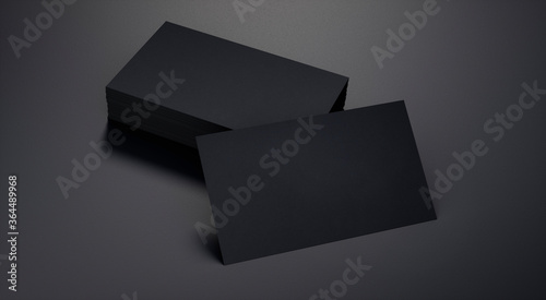 Leere schwarze Visitenkarten mit Stapel auf schwarzem Leder
