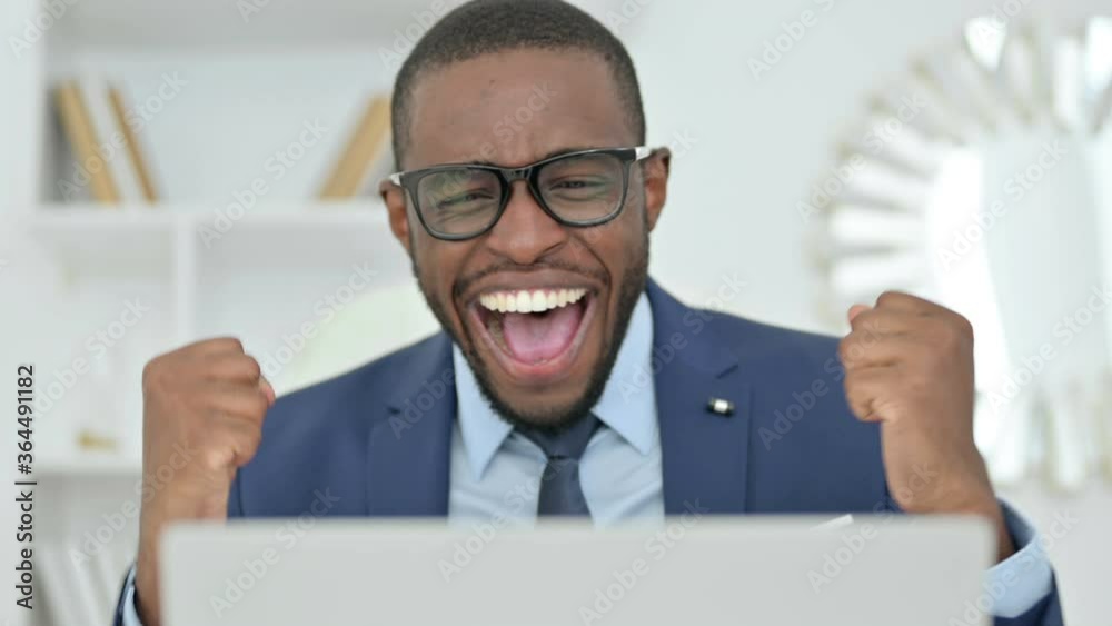 Portrait of African Businessman Celebrating Success on Laptop Portrait of African Businessman Celebrating Success on Laptop