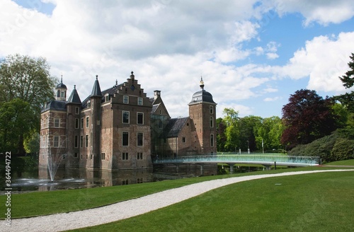 Historic castle with glass bridge and towers in a park with trees in the background. 16th century dutch architecture. Famous landmarks of the netherlands. 