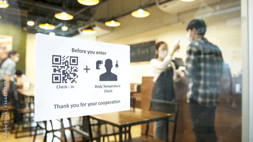 Check in and body temperature check paper sign measure in front of restaurant with staff scan body temperature and scan QR code for check in. New normal for protection covid-19 after reopening. Check in and body temperature check paper sign measure in front of restaurant with staff scan body temperature and scan QR code for check in. New normal for protection covid-19 after reopening.