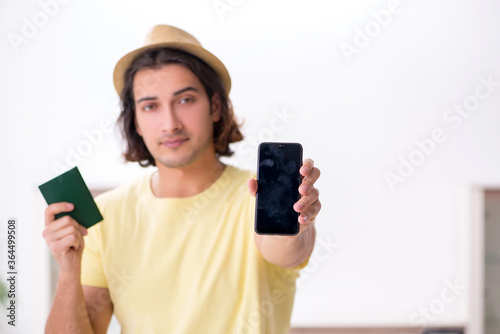Young man holding passport preparing for summer trip
