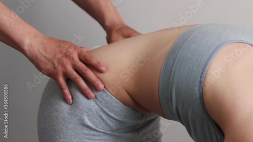 Wallpaper Mural Young woman bending down in the cabinet of massagist Torontodigital.ca