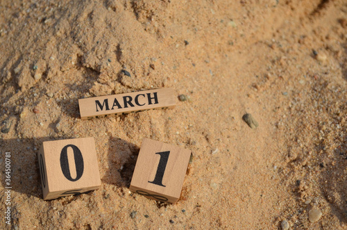 March 1, Number cube with Sand pile for a background.