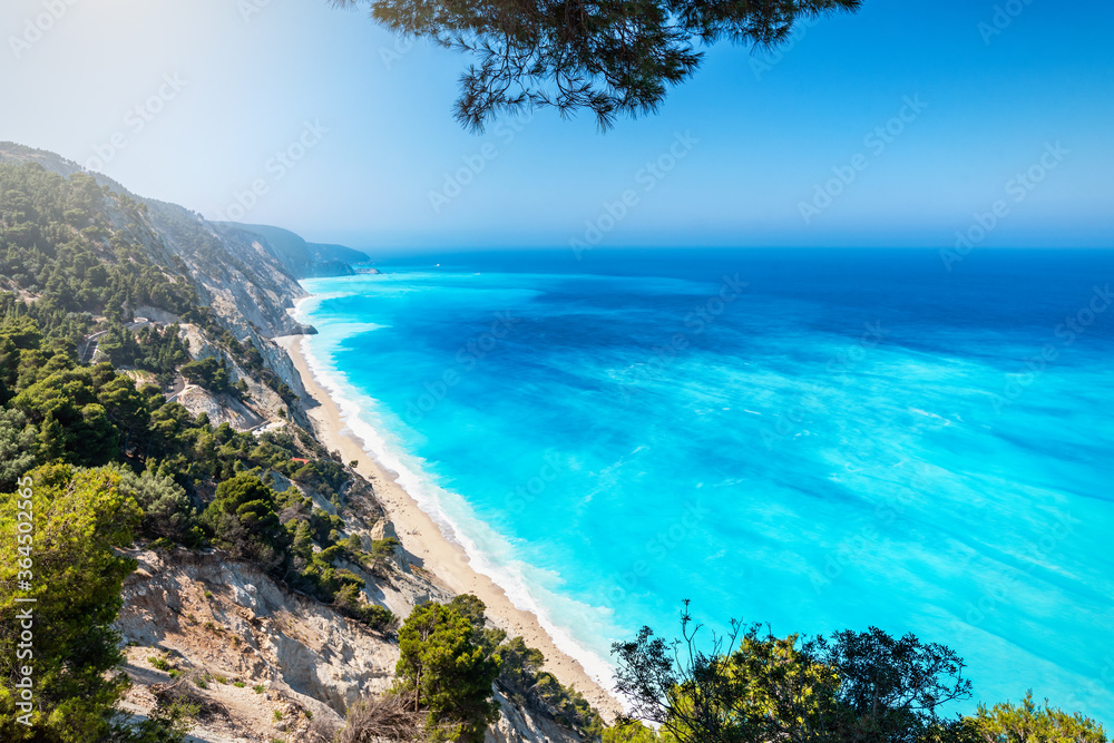 Panoramic view to the popular beach of Egremni on the island of Lefkada with fluorescent blue sea, Greece