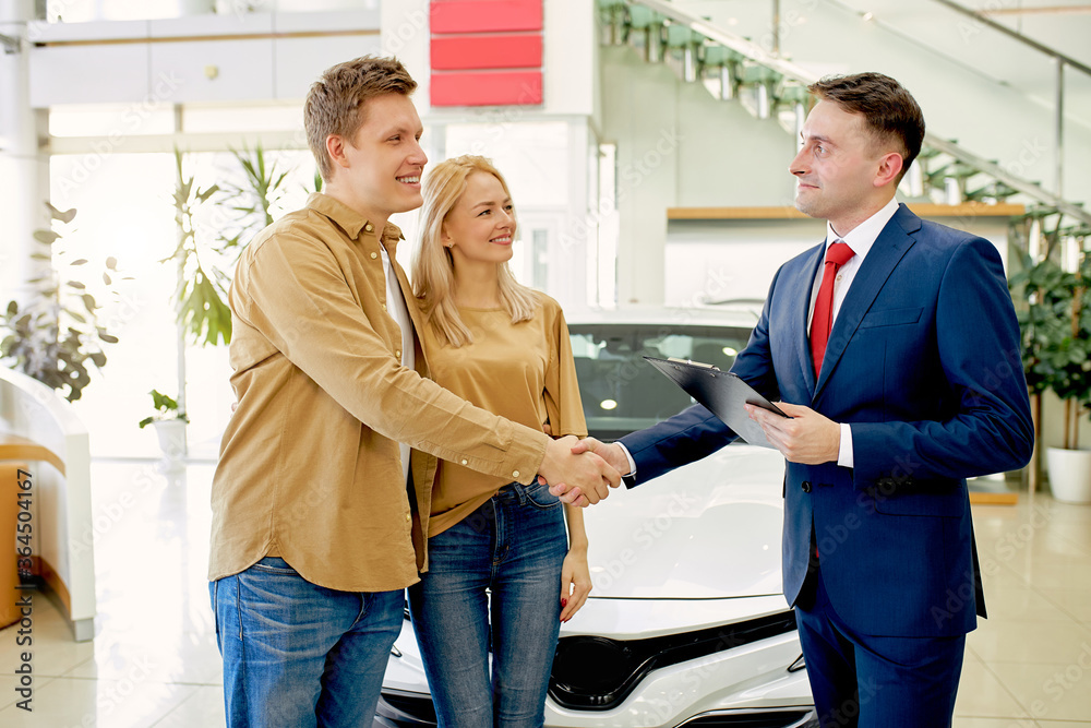 consultant celebrate customer with successful purchase of car in their dealership, men shaking hands to each other. pleasant staff consultant celebrate customer with successful purchase of car in their dealership, men shaking hands to each other. pleasant staff
