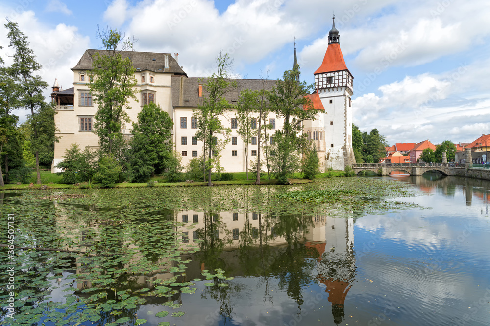 View of the Blatna Castle in the Czech Republic with reflection in the water.