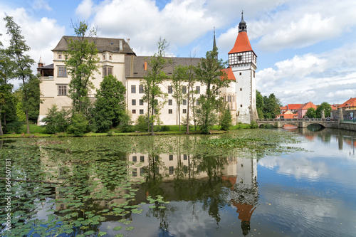 View of the Blatna Castle in the Czech Republic with reflection in the water.