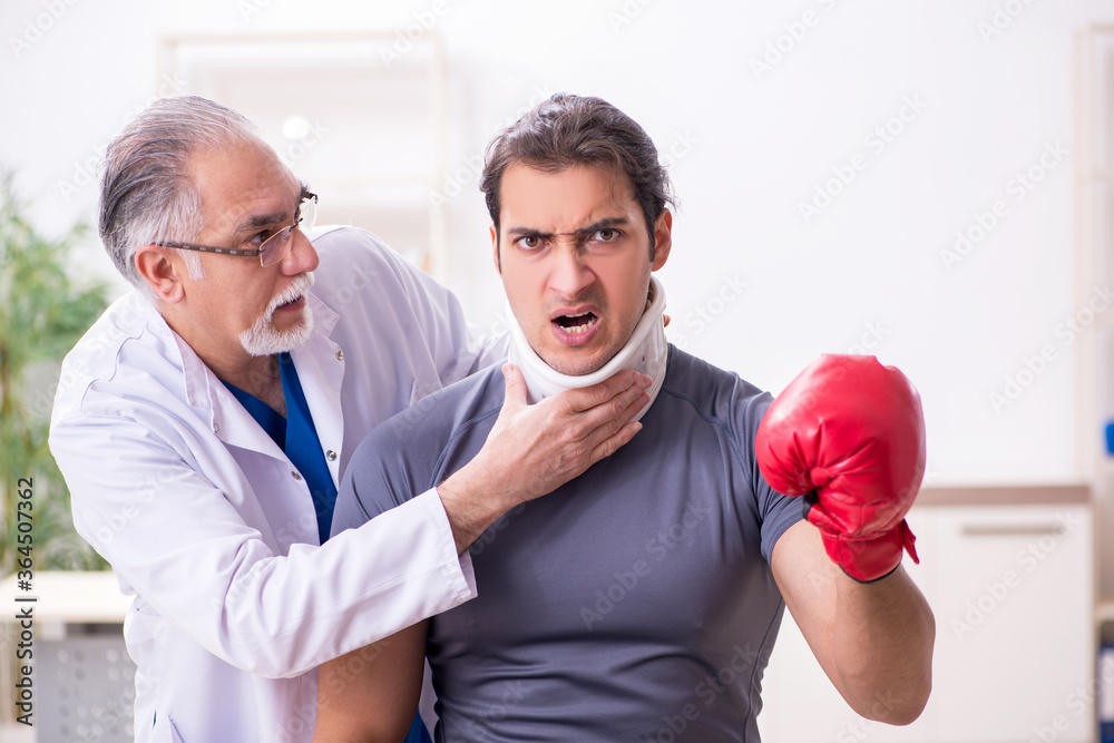 Young injured boxer visiting old doctor traumatologist Young injured boxer visiting old doctor traumatologist