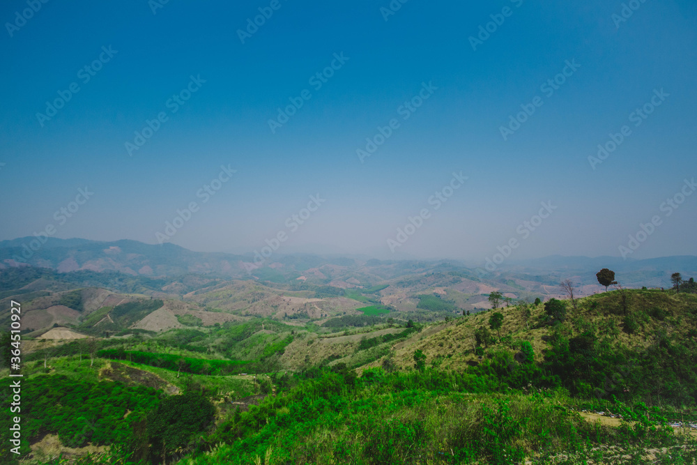 Watching the view on the top of a high hill Watching the view on the top of a high hill
