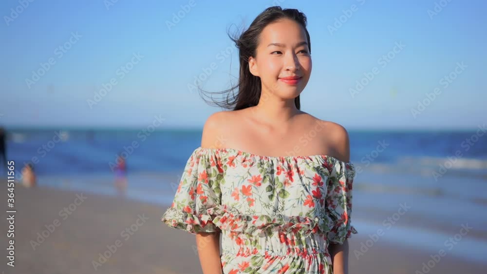 Liberated free asian woman cherishing life on beach Liberated free asian woman cherishing life on beach