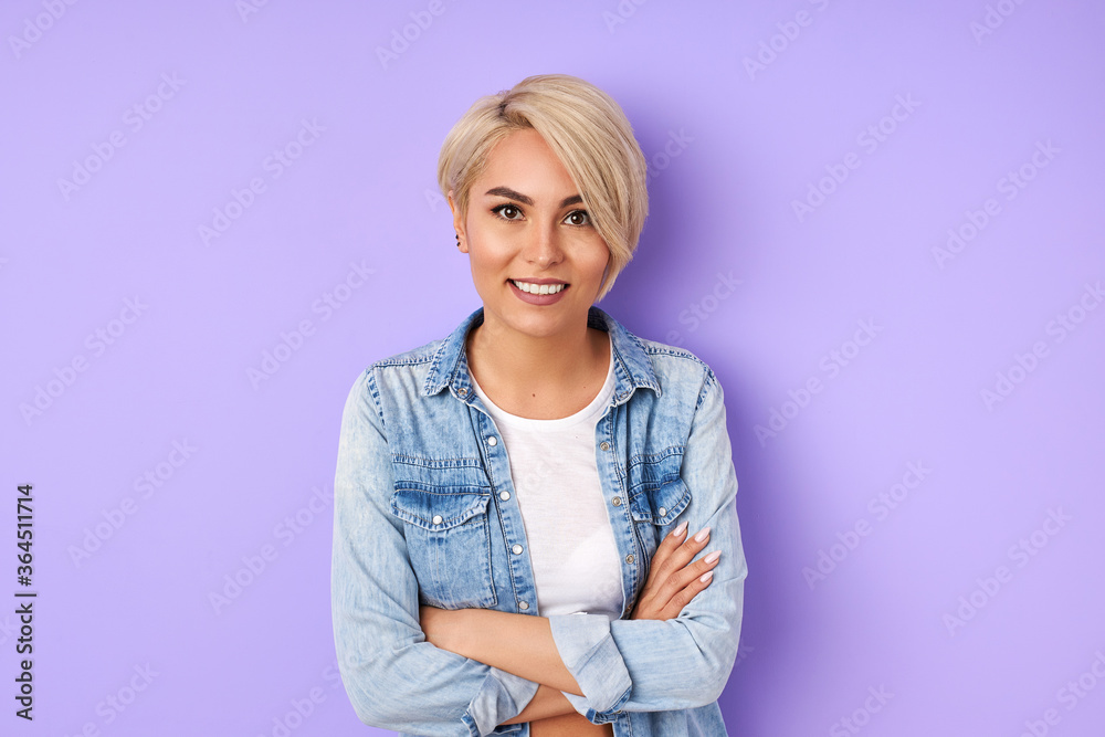 portrait of calm caucasian smiling woman isolated over purple background. young good-looking female is restrained in manifestations of emotions portrait of calm caucasian smiling woman isolated over purple background. young good-looking female is restrained in manifestations of emotions