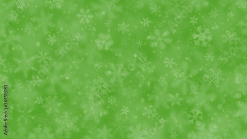 Christmas background of snowflakes of different shapes, sizes, blur and transparency in green colors