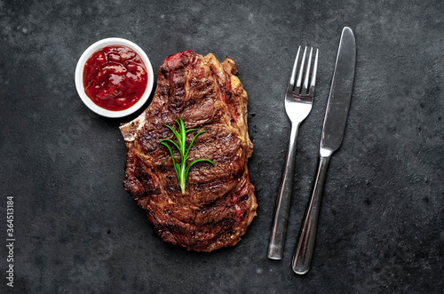 Marbled beef steak grill with spices on a stone background