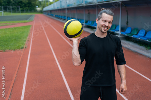 athlete and personal trainer with medicine ball has workout outdoor