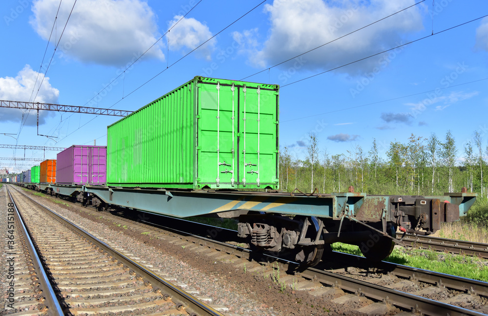 Naklejka premium Cargo Containers Transportation On Freight Train By Railway. Intermodal Container On Train Car. Rail Freight Shipping Logistics Concept. Out of focus, object in motion.