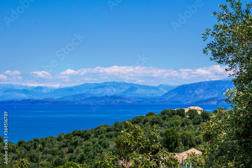 Beautiful landscape with sea bay with turquoise water, rocks and cliffs, green trees and bushes. Corfu Island, Greece.