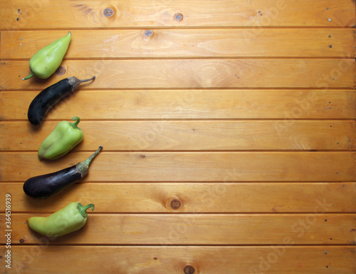 eggplants and sweet peppers on wooden background flat lay