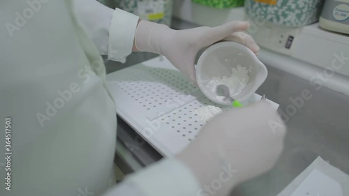 Handling pharmacy, weighing raw material for drug production.