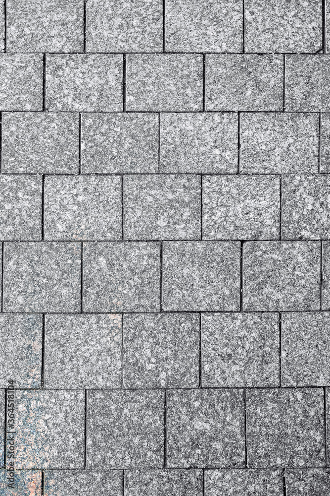 Naklejka premium fragment of granite street cover from a rectangular stone in St. Petersburg, Russia