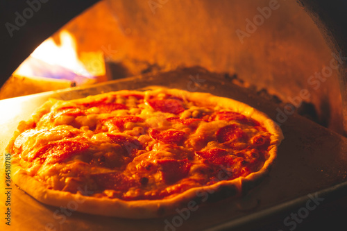 Salami Pizza Into the oven have fire burn near cooked