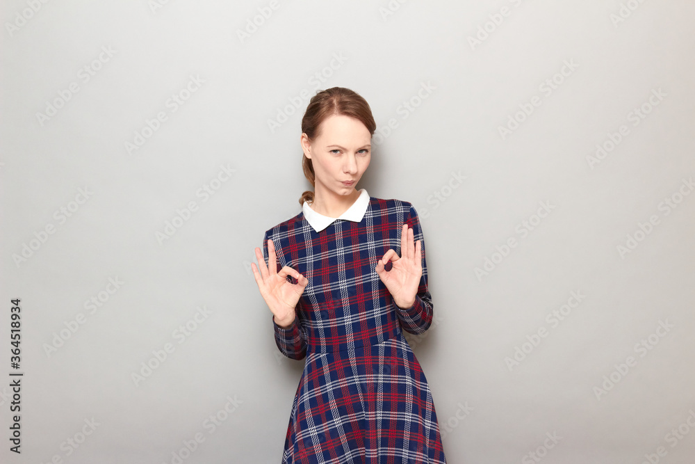 Portrait of happy and proud young woman showing okay gestures Portrait of happy and proud young woman showing okay gestures